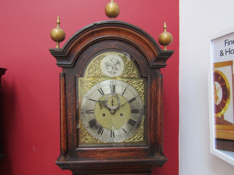 A George III oak longcase clock, the brass broken arch 11.5'' dial with silvered chapter ring,