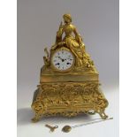 A 19th Century French gilt spelter and brass figural mantel clock depicting maiden with exotic pet