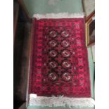 Two early 20th Century red ground rugs of small proportions,