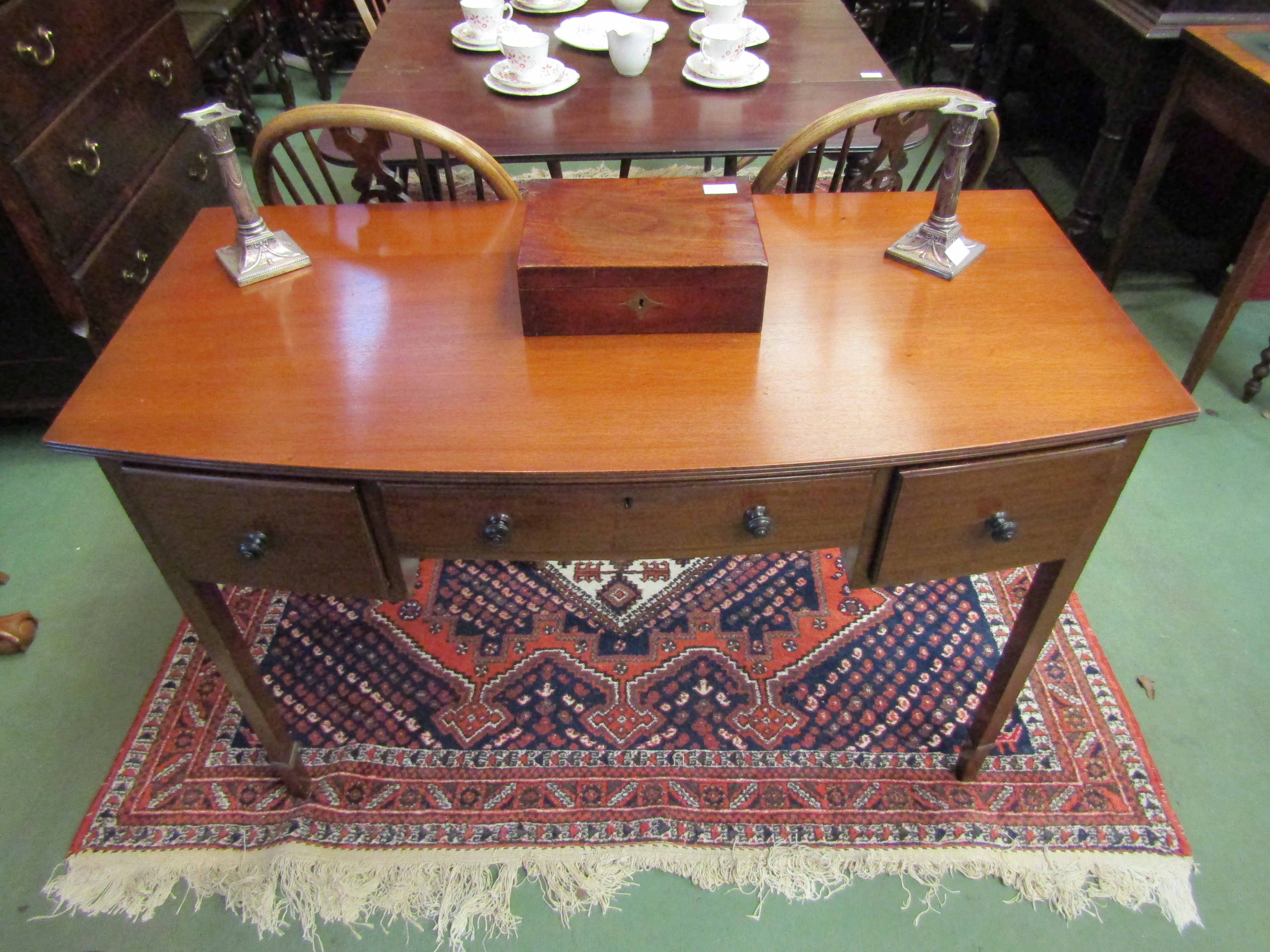 A Waring & Gillow mahogany side table, single drawer flanked by two drawers, tapering legs,