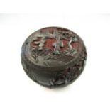 A Chinese red and black cinnabar lacquer box for rouge, 13cm diameter, black lacquered interior,