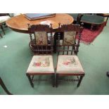A pair of 19th Century mahogany child's chairs, each with a heavily carved top rail,