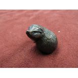 A limited edition bronze hedgehog, sniffing.