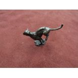 A miniature solid bronze running cheetah