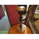 A turned wood wig stand