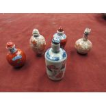 Five Oriental porcelain snuff bottles in blue and red,