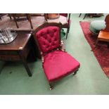 A late Victorian walnut nursing chair,