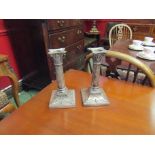 A pair of silver candlesticks of swag design,