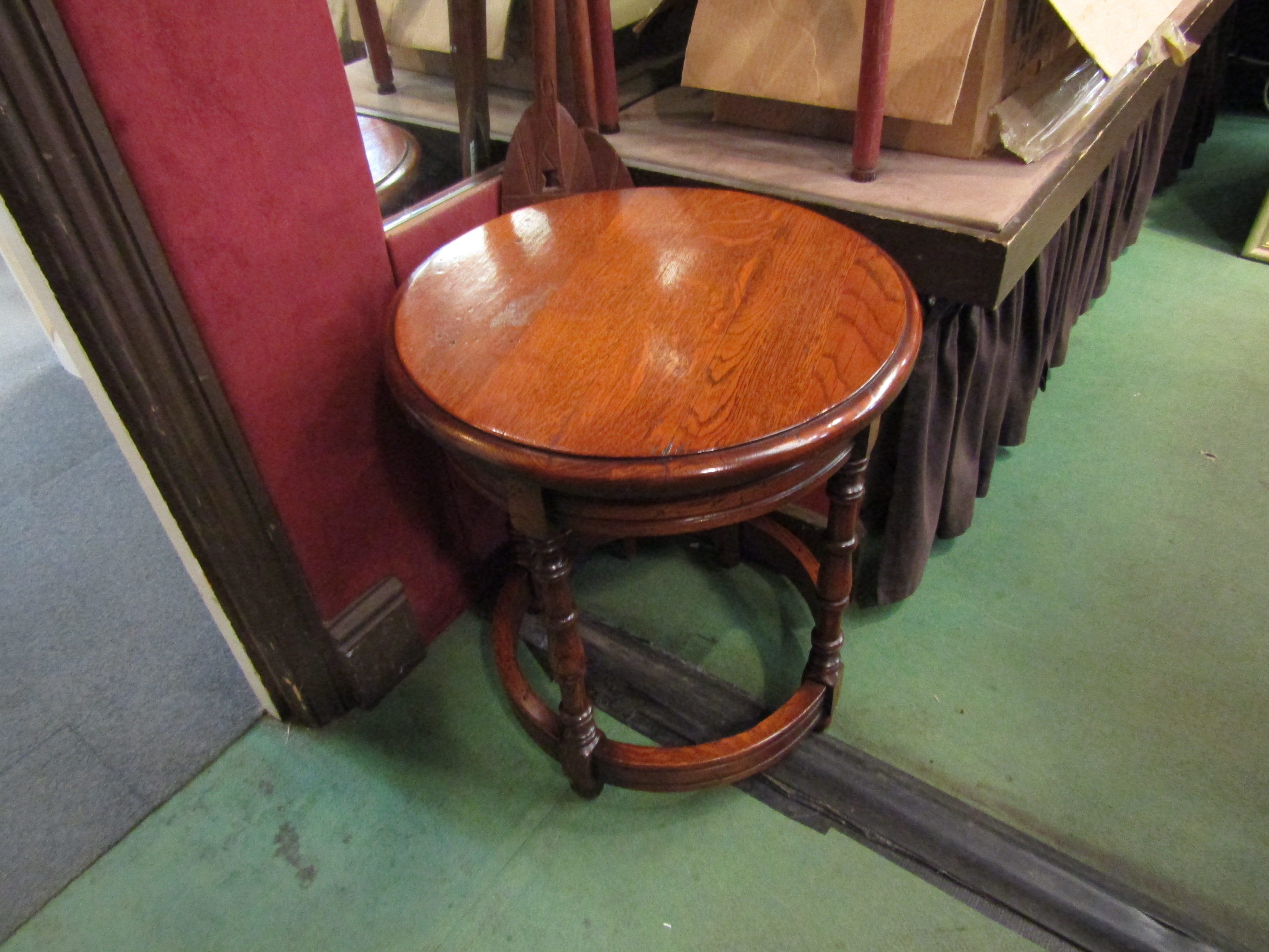 An 18th Century style oak occasional drum table with single frieze drawer on turned legs joined by