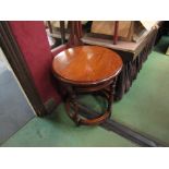 An 18th Century style oak occasional drum table with single frieze drawer on turned legs joined by