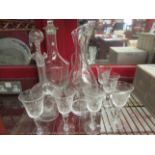 An etched glass drinking set comprising of glasses, carafe,