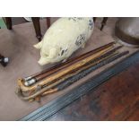 Seven assorted walking sticks including silver knop,