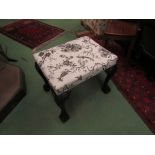 A 19th Century mahogany stool the upholstered seat over ball in claw carved cabriole legs with