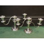 A pair of silver plated on copper three branch candelabra by Barker Ellis