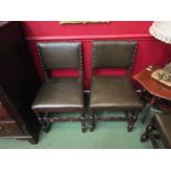 A set of six 18th Century style oak and leather dining chairs with brass stud decoration on turned