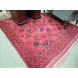 A large 20th Century Eastern red ground wool carpet