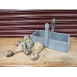 Four Victorian cast iron ball and claw bath feet in a blue painted tool trug