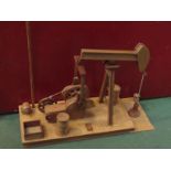A scratch built American wooden model of a nodding donkey oil rig,