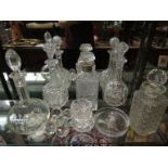 Five decanters (one with silver collar), knife rests,