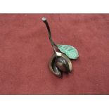 A limited edition cold painted bronze conker with leaf,