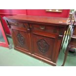 A Victorian walnut sideboard with carved front, two drawers and twin cupboard doors,
