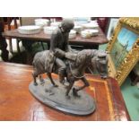 A bronzed effect metal sculpture of "John Wesley" on horseback