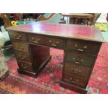 A Victorian walnut twin pedestal desk the tooled leather writing surface over nine drawers on a