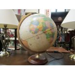 A vintage style illuminating world globe with electric bulb.
