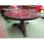 A 19th Century rosewood centre table with trefoil plateau base to lion paw feet,