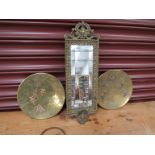 An antique pressed brass mirrror and a pair of Oriental brass and copper plates (3 - a/f)