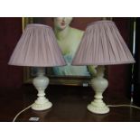 A pair of painted plaster table lamps with pleated shades