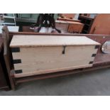 A large Victorian pine box with metal banding and latch 137cm wide