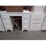 A white painted four drawer chest,