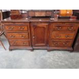 A Georgian oak dresser base with central inverted door,