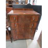 A 1930's walnut four drawer bedroom chest with metal handles