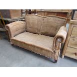 An Edwardian mahogany drop-end sofa on square tapering legs,