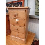 A bedside chest of four pine drawers