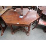 A 19th Century walnut octagonal table on barleytwist legs joined by shaped and pierced stretchers