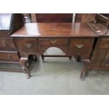 A Georgian revival oak lowboy with three drawers