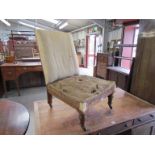 A Victorian ladies fireside chair on walnut turned legs,