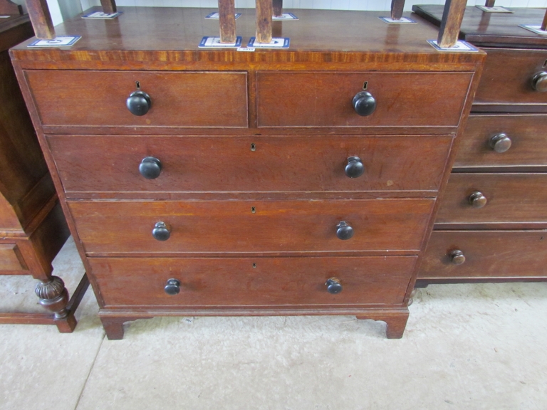 A George III two over three oak chest of drawers