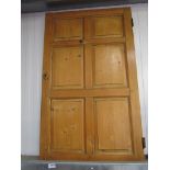 A Georgian waxed pine six panel cupboard door with lock and key