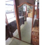 A 1930's walnut framed arch top dress mirror 137cm tall