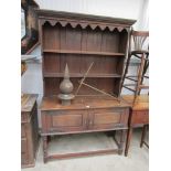 An Arts and Crafts oak two door dresser in two sections 122w x 195cm tall