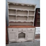 A modern painted pine three drawer over two door dresser,