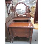 A 1940's oak dressing chest with mirrored back