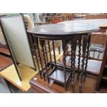 A nest of three 1930's oak barley twist tables with oval tops