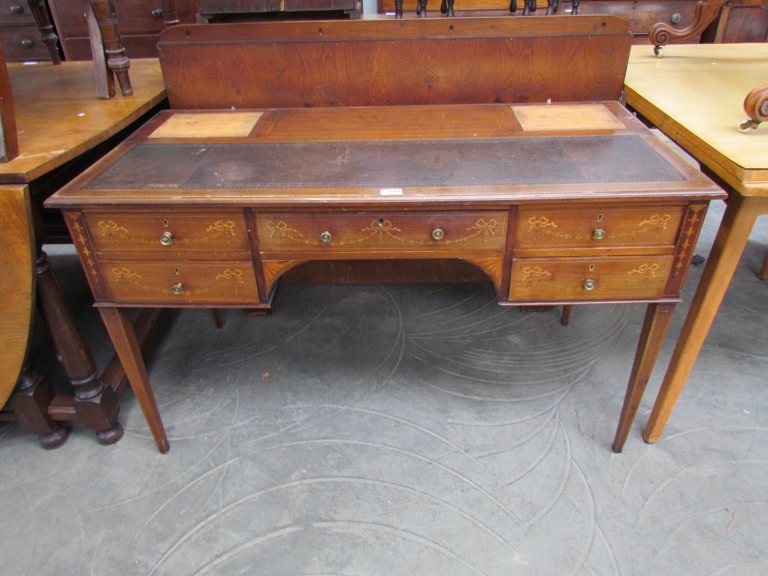 A Georgian Sheraton period inlaid mahogany writing desk with five drawers and brass mushroom shaped