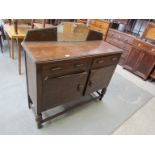 A 1940's oak sideboard with gallery back and two drawer, two door front,