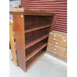 A medium oak bookcase with four tiers